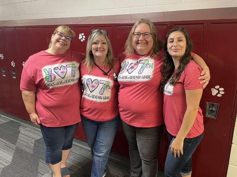 four female teachers all wearing identical red t-shirts