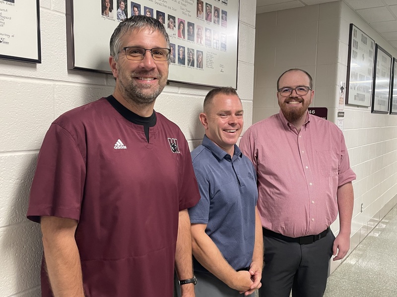 4 male high school teachers smiling