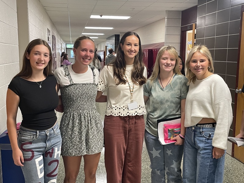 group of five high school girls standing arm in arm