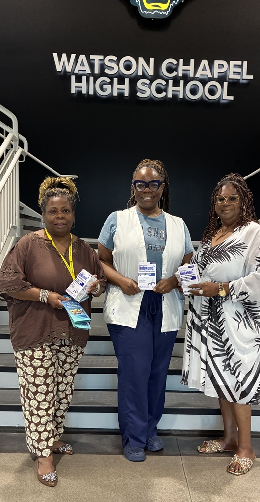 3 women standing in front of the stairs holding boxes and smiling