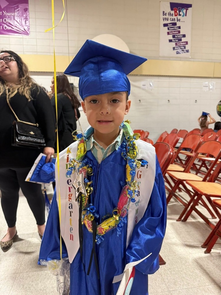 Student wearing a blue cap and gown