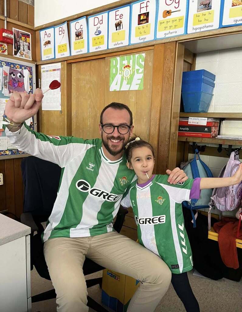 Teacher and student wearing a soccer jersey