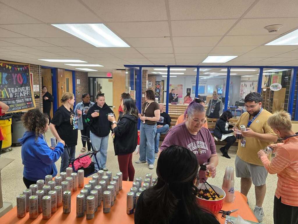 School staff members gathering in a hallway to grab refreshments