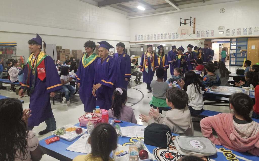 Waukegan High School students visiting elementary students at Clark's Elementary gym.