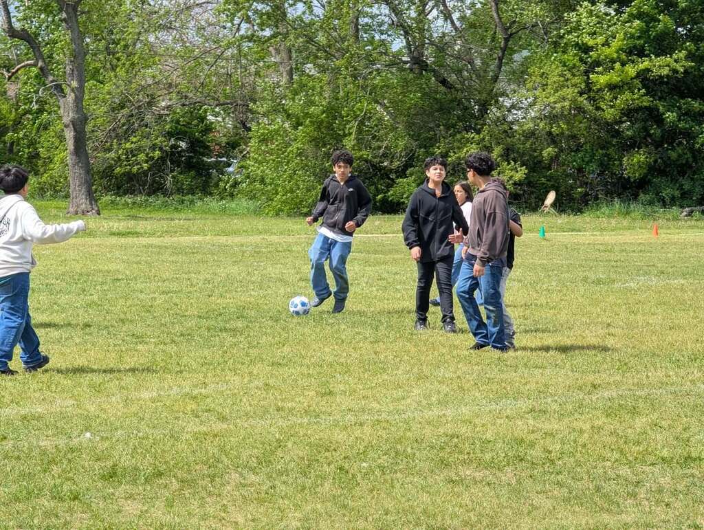 students playing soccer in a field day