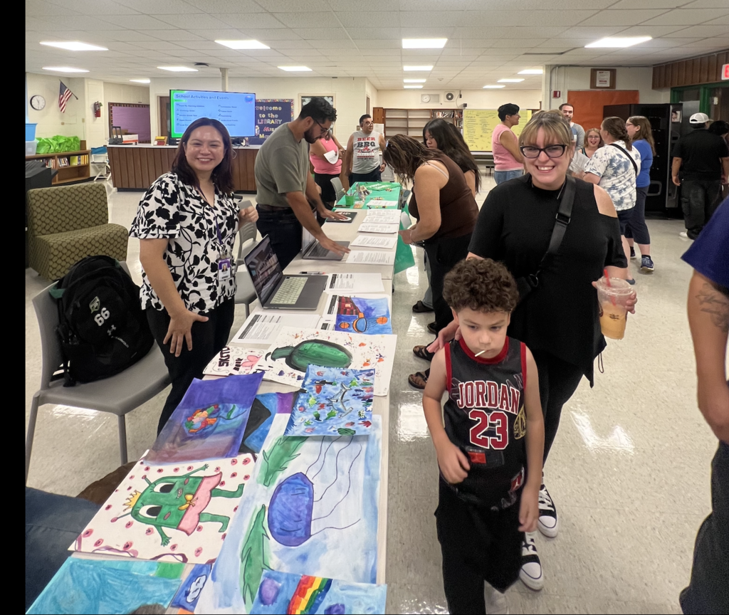 Families meeting with Encore teachers in the library.