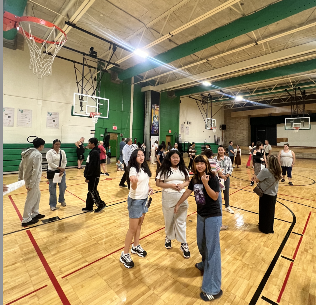 7th and 8th grade students and families in the gym.