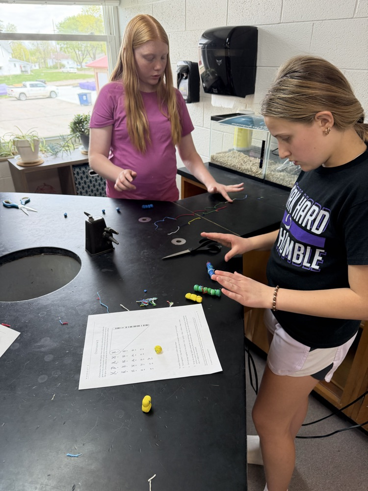 girls making model chromosomes from clay and string