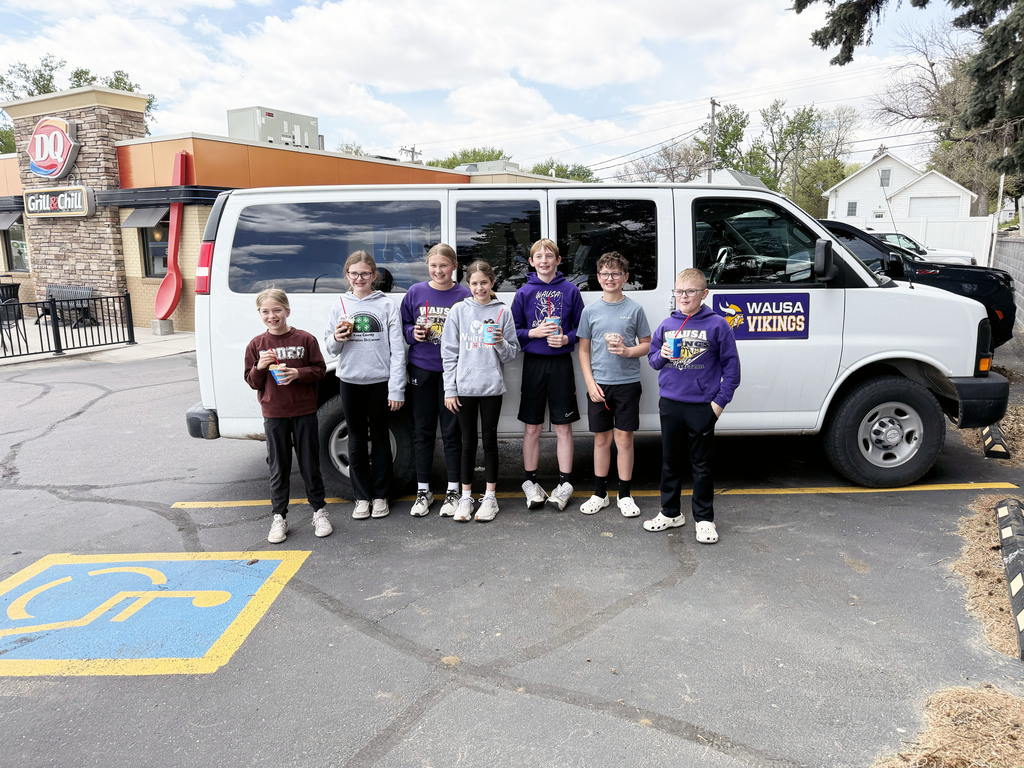 Group photo of students in front of the school van outside of Dairy Queen in Wayne, NE
