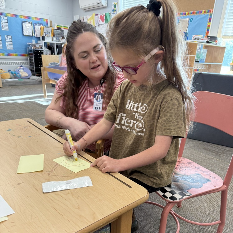 a preschooler is learning with a teacher