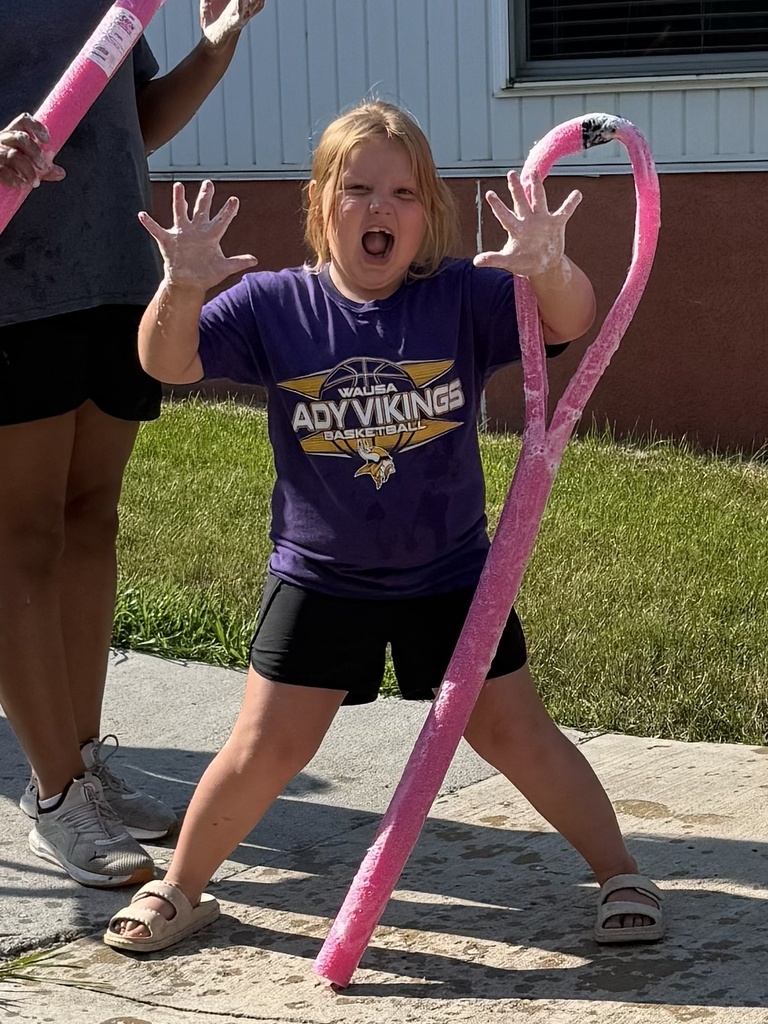 Students use a bubble wand to make giant bubbles.
