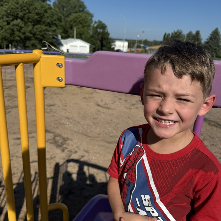 A first grade student pictured near the praying mantis