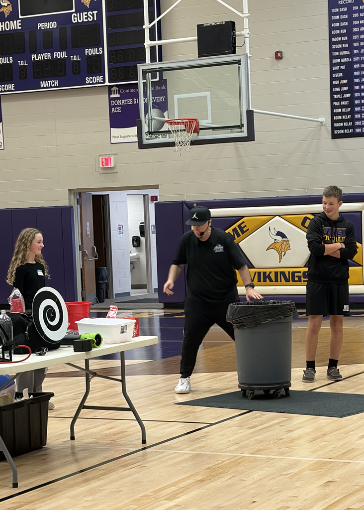Colton and Jaryn assist Rob Holla with a pressure in a can experiment.