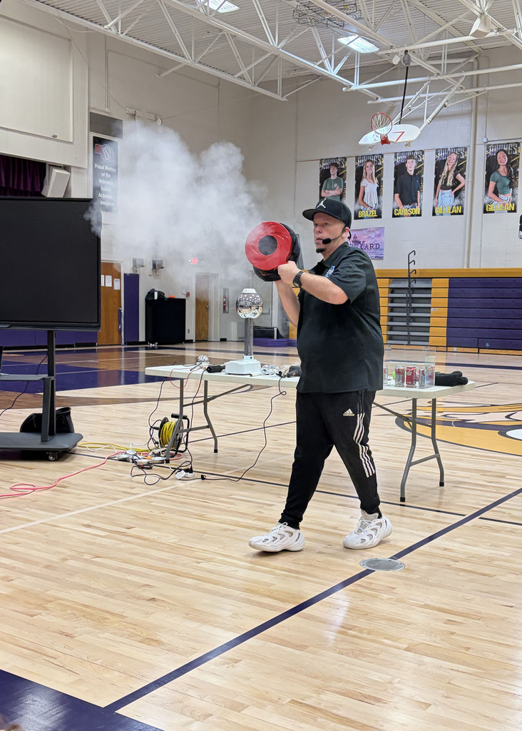 Rob Holla does a cloud demonstration and shoots clouds into the elementary crowd.