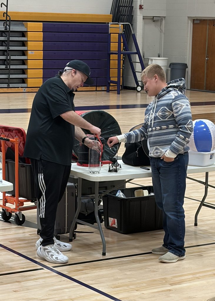 Rob Holla shows Vincent how to make a cloud at today's assembly.