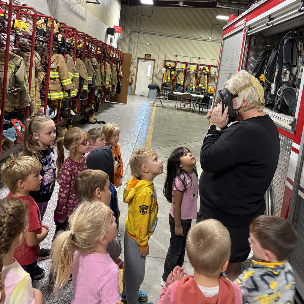 Amy Johnson demonstrates the fire masks to the preschool students.