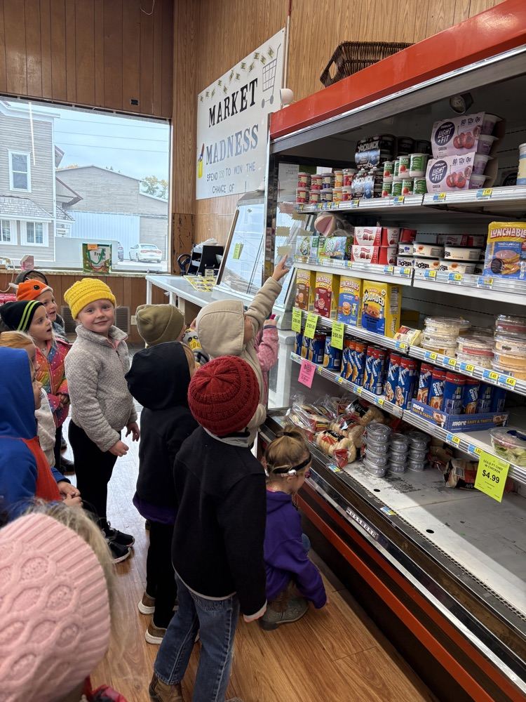 PreK students looking up at the letter G puppet behind the GoGurt