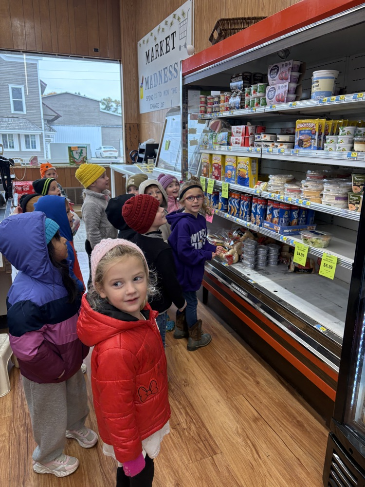 PreK students looking up at the letter G puppet behind the GoGurt