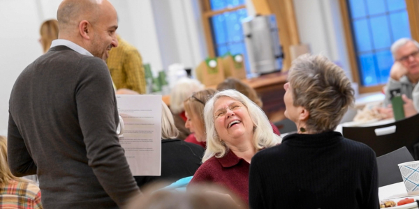 Seniors laughing and talking together at a table
