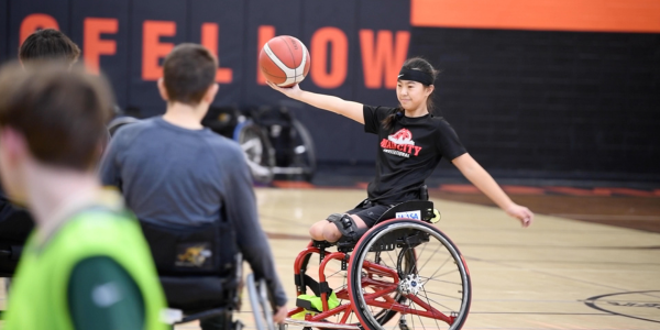 student athlete playing wheelchair basketball
