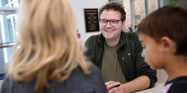 visiting author smiling at students