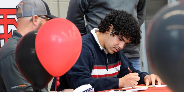 photo from 2025 event of student signing