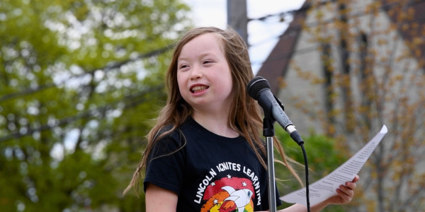 Student speaker smiling at microphone