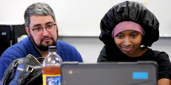 counselor helping student on laptop