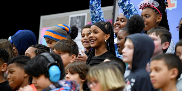students smiling while singing