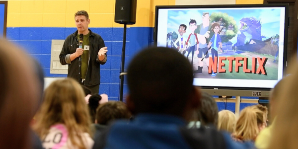 Photo of author speaking to students