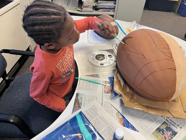 Student painting pumpkin