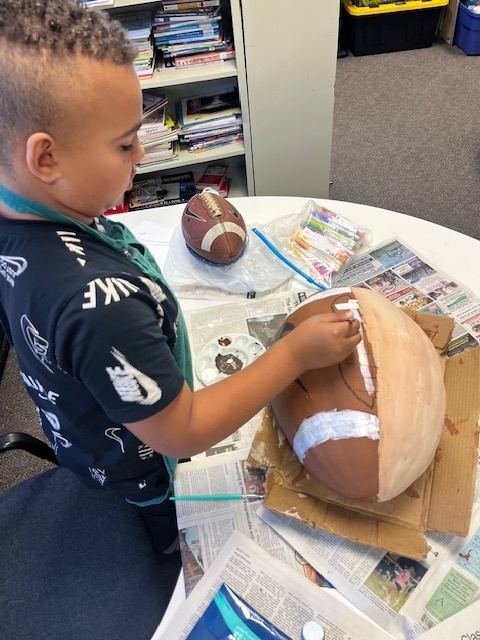 Student painting pumpkin
