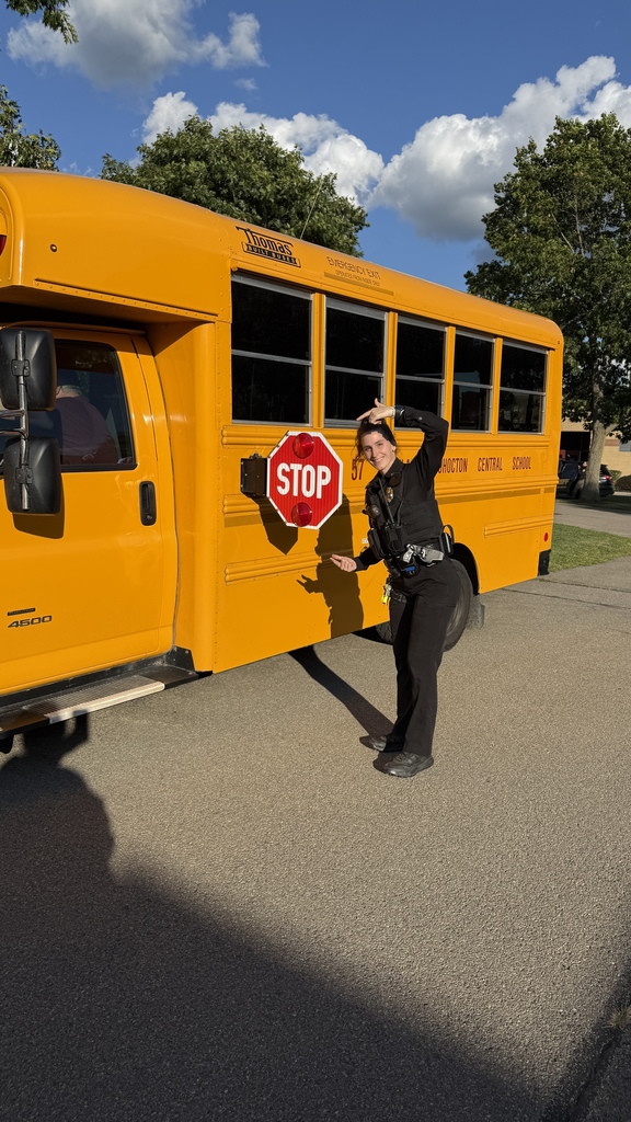 Officer VanDunk points out the stop sign on a WCCS school bus.