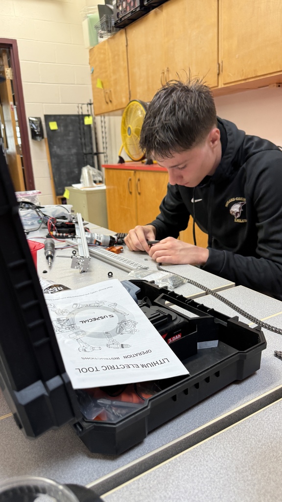 Owen works on assembling a section of chain.