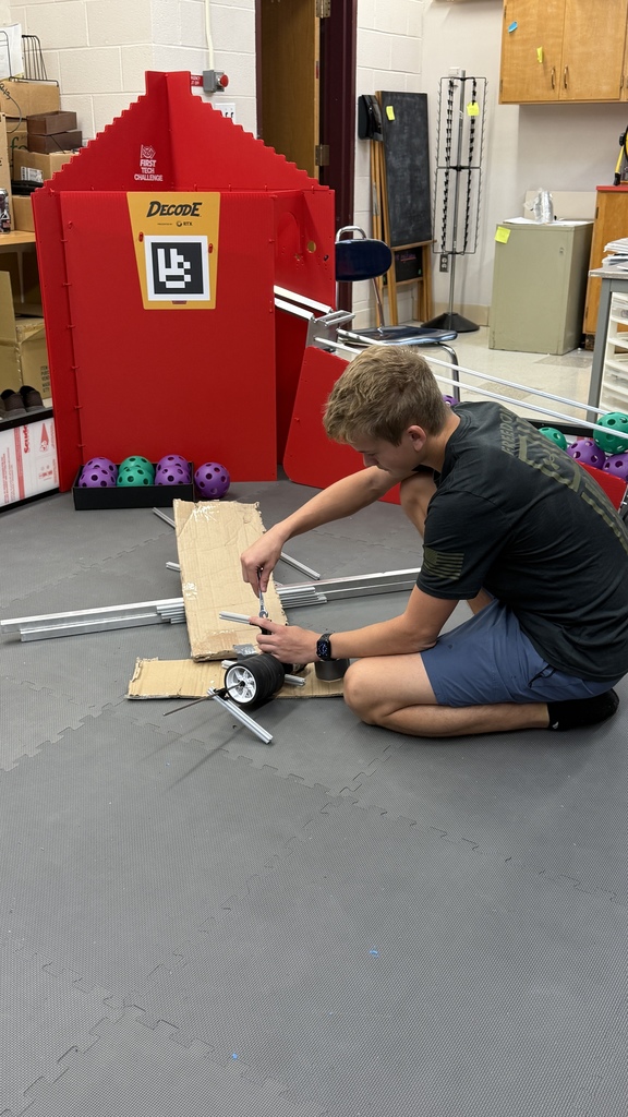 Tosh works on an assembly to throw balls.