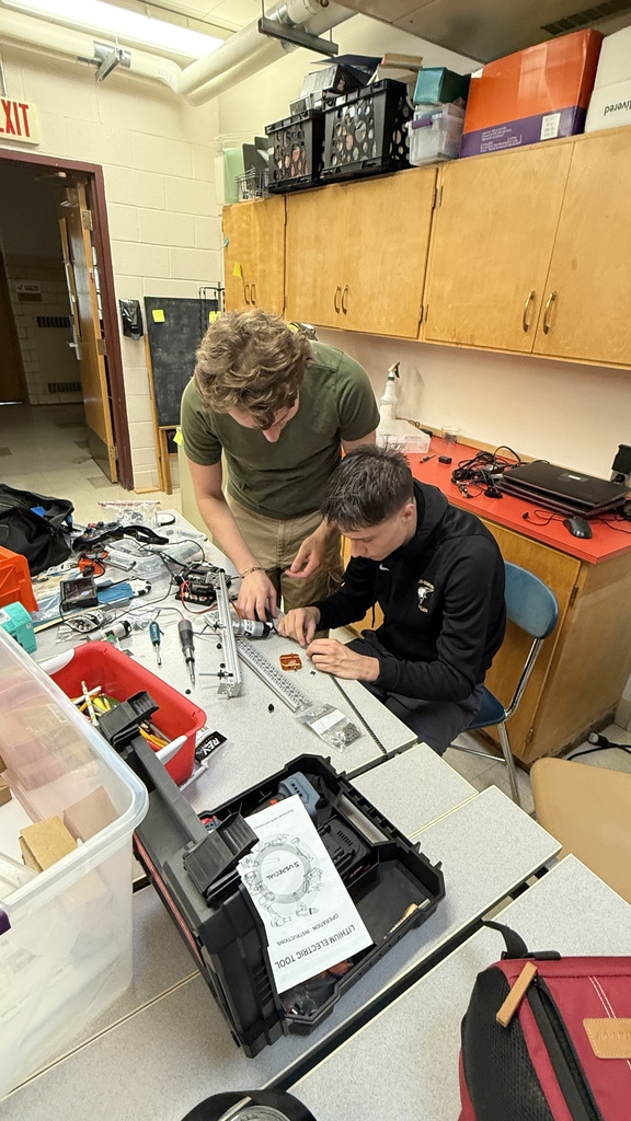 Elijah and Owen work to assmeble a section of chain.