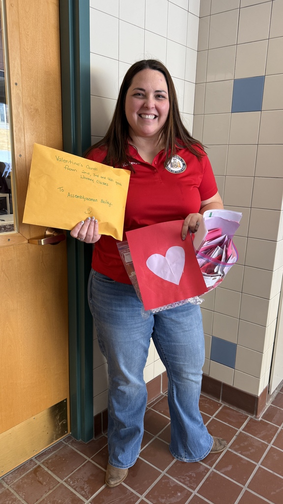 Katelyn Ellison, Chief of Staff for Assemblywoman Andrea Bailey picks up student-created valentines at Wayland-Cohocton Elementary School