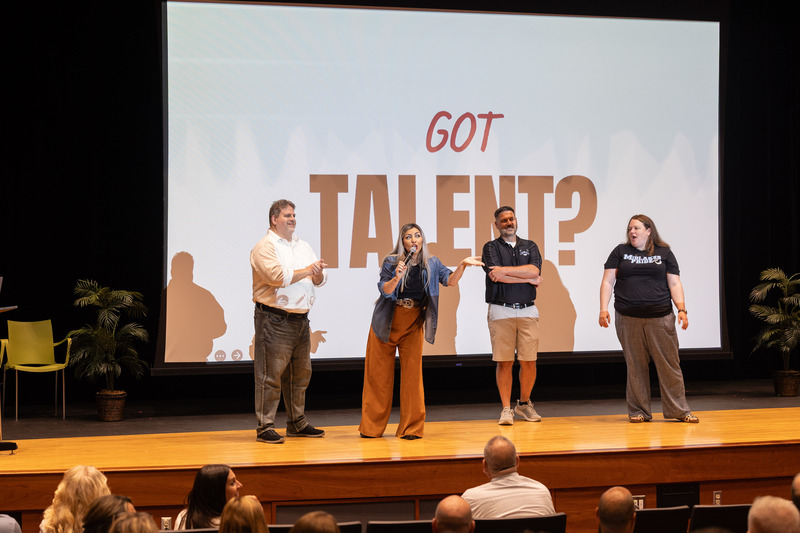 Dr. Julia Garcia, second from left, stands on stage with three participants from the audience.