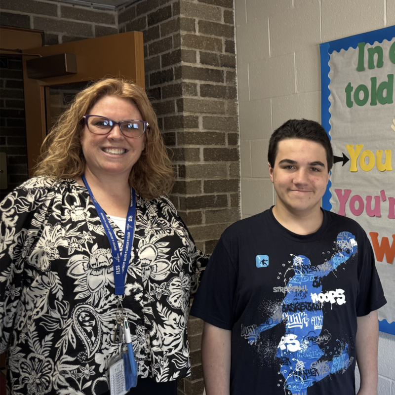 Alison Cantu smiles with a student at FLSS for a photo