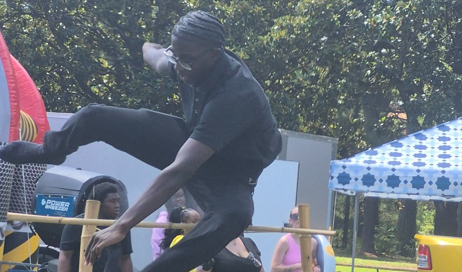 Student jumping in high jump event at Beginning of the year Bash.