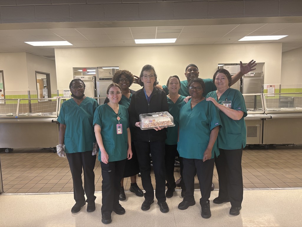 8 cafeteria workers smiling infant of cafeteria