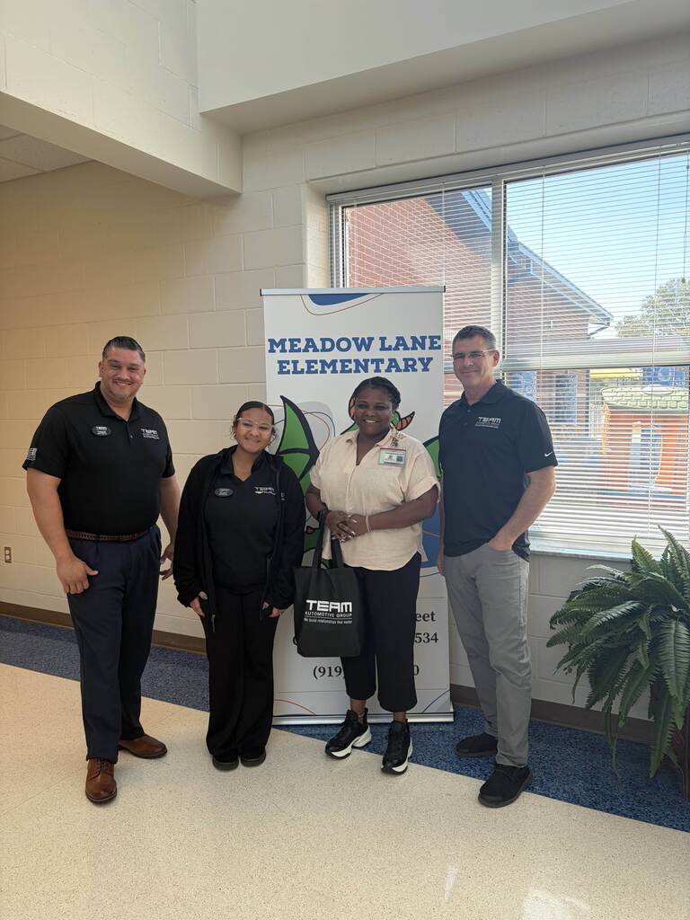 Mrs. Relaford, assistant principal, standing with 3 team members from TEAM Chevrolet