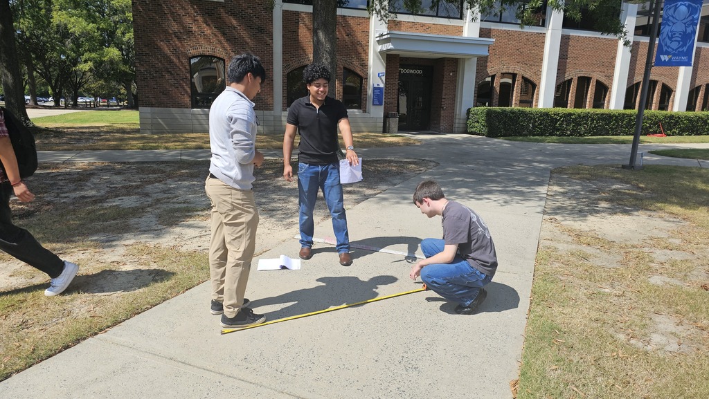 Students outside measuring right triangles