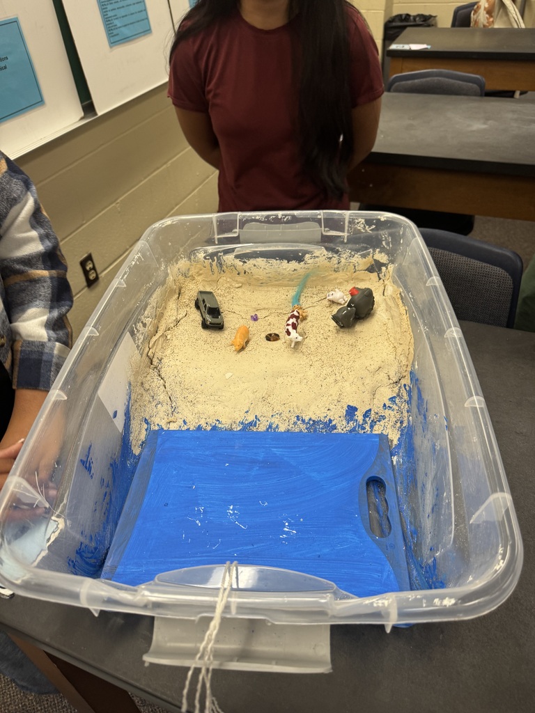 Beach model with sand in a rubber maid container.
