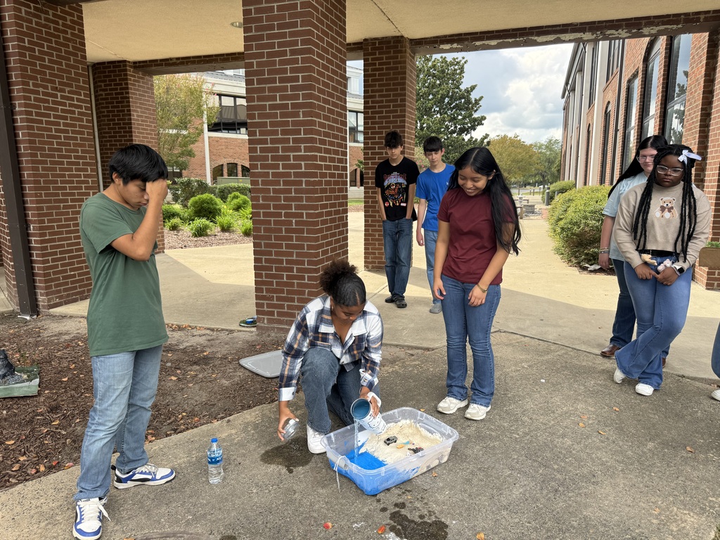 Students are outside testing their tsunami models.