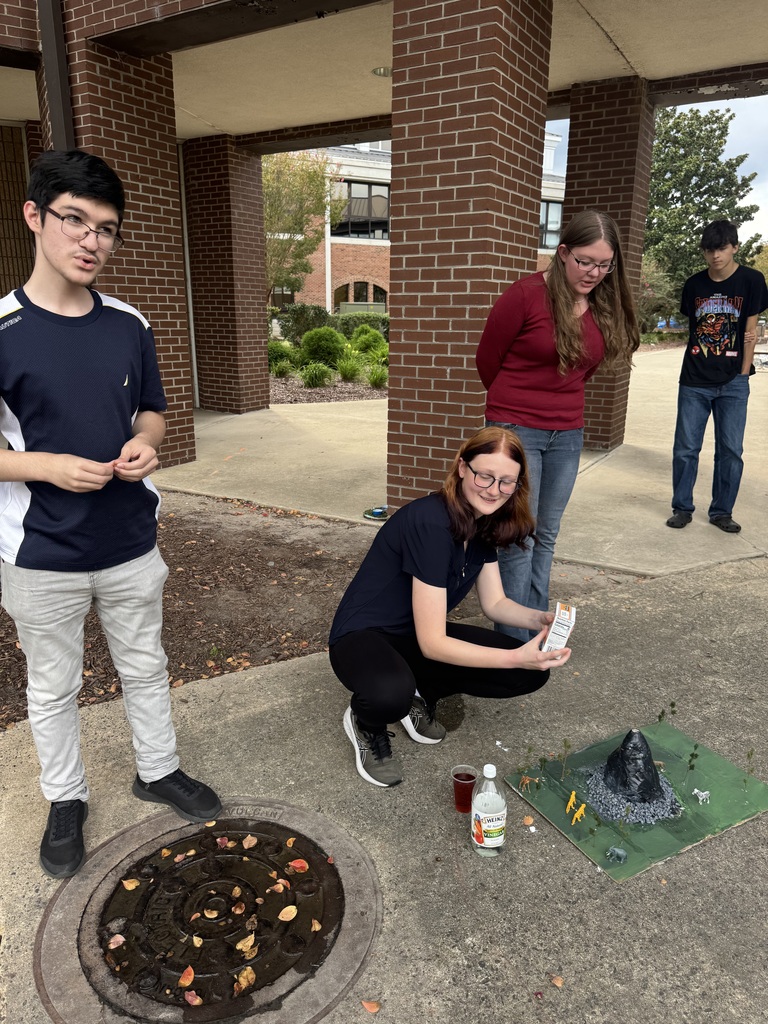 Students are outside testing their volcano models