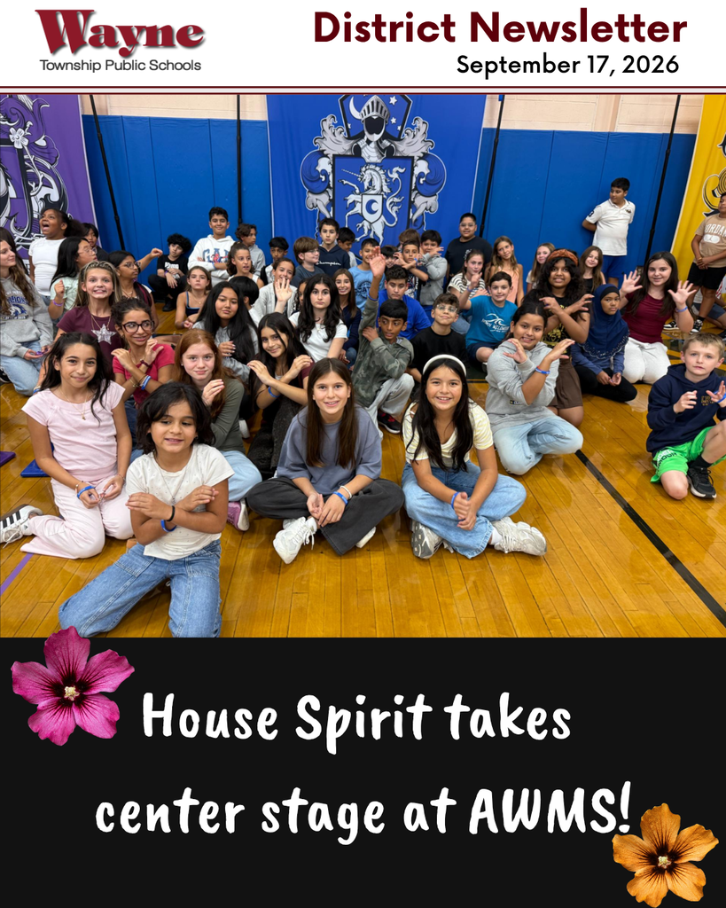 A group of students poses for a picture in a gym. A text overlay reads "House Spirit takes center stage at AWMS."