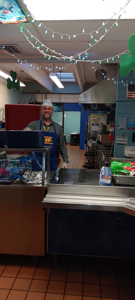Breakfast volunteer standing behind the counter