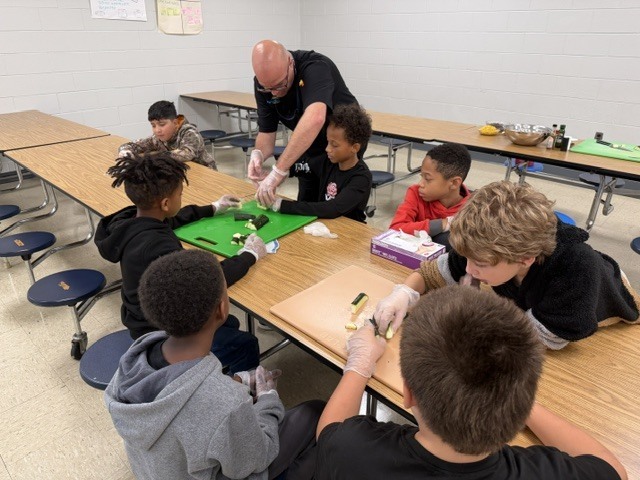 Chef Jason teaching knife skills to a group of students
