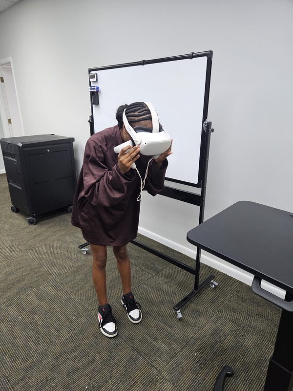 Student deworming a dog using VR to explore a career in veterinary.